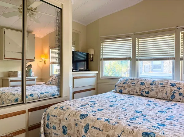 a bedroom with a large bed and a window