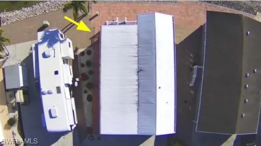 a view of sign board with buildings in background