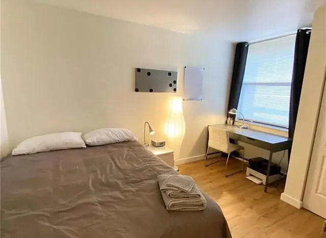 a bedroom with a bed and a table in it