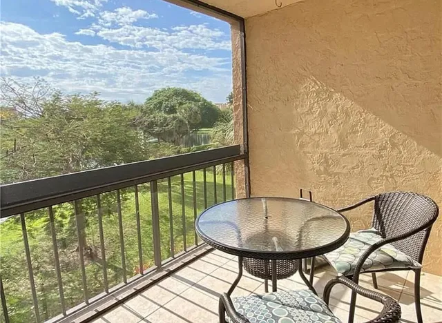 a view of a balcony dining table and chairs