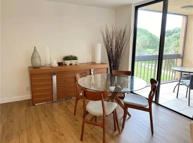 a dining room with furniture and wooden floor