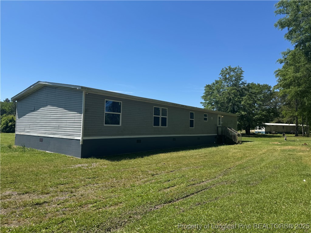 2273 Bee Gee Road Lumberton, NC 28358 - Photo 13 of 35 a backyard of a house with lots of green space