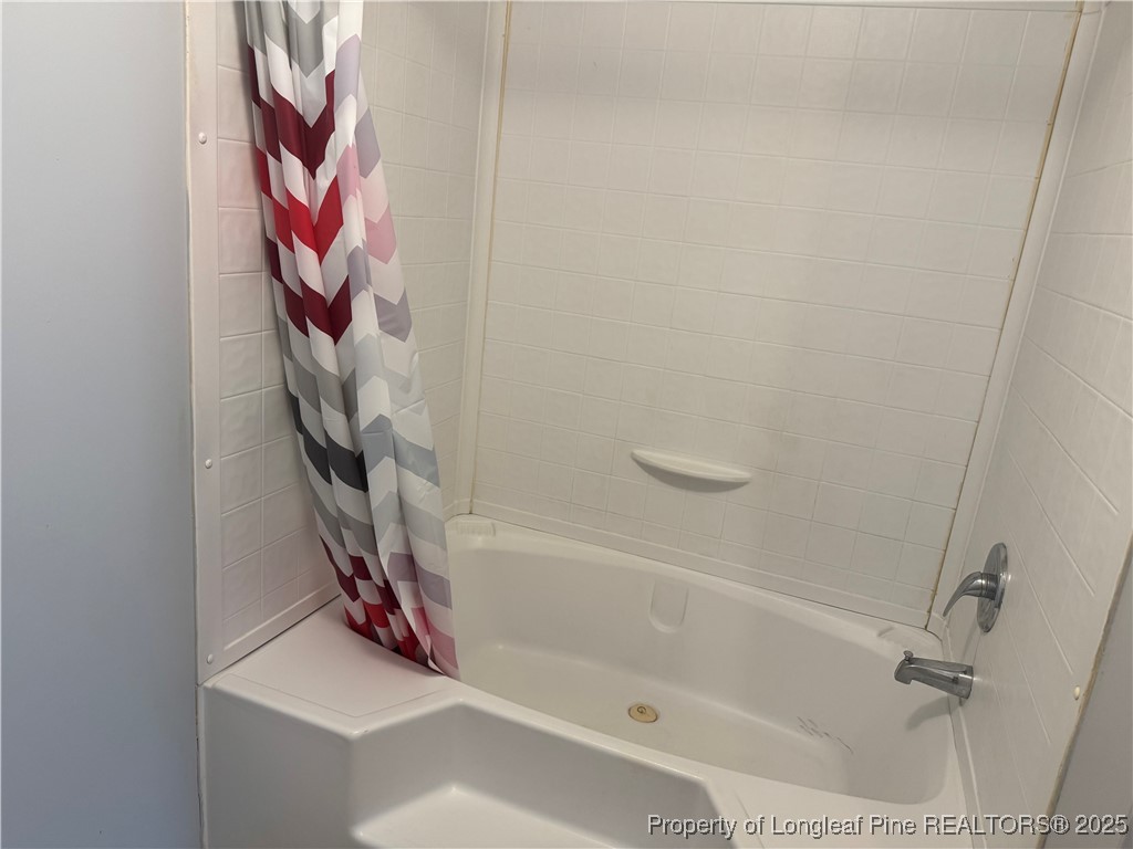 2273 Bee Gee Road Lumberton, NC 28358 - Photo 19 of 35 a bathroom with a bathtub and a shower