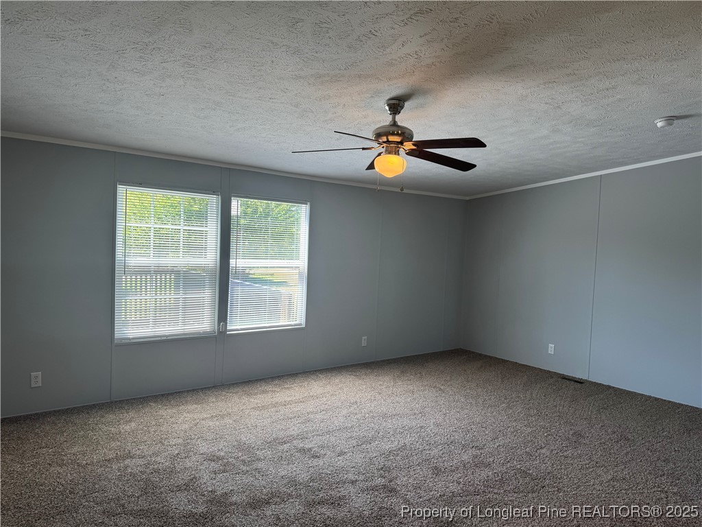 2273 Bee Gee Road Lumberton, NC 28358 - Photo 21 of 35 an empty room with windows and ceiling fan