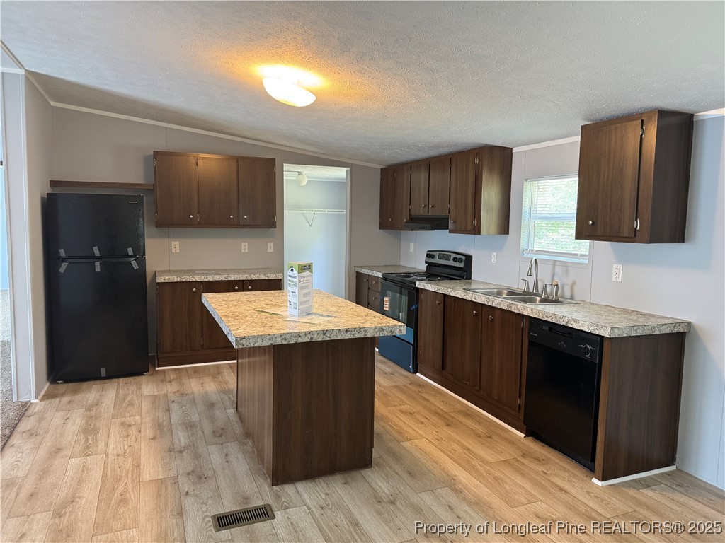 2273 Bee Gee Road Lumberton, NC 28358 - Photo 22 of 35 a kitchen with a sink a counter top space and cabinets