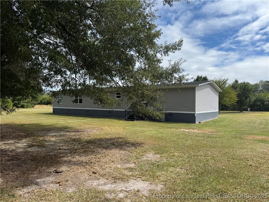 2273 Bee Gee Road Lumberton, NC 28358 - Photo 8 of 35 a backyard of a house with lots of green space