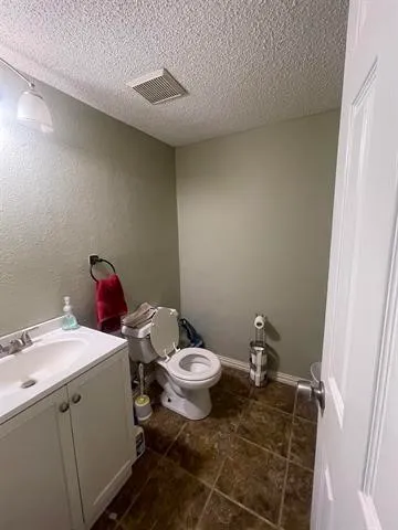 a large kitchen with stainless steel appliances granite countertop a stove a sink dishwasher and cabinets with wooden floor