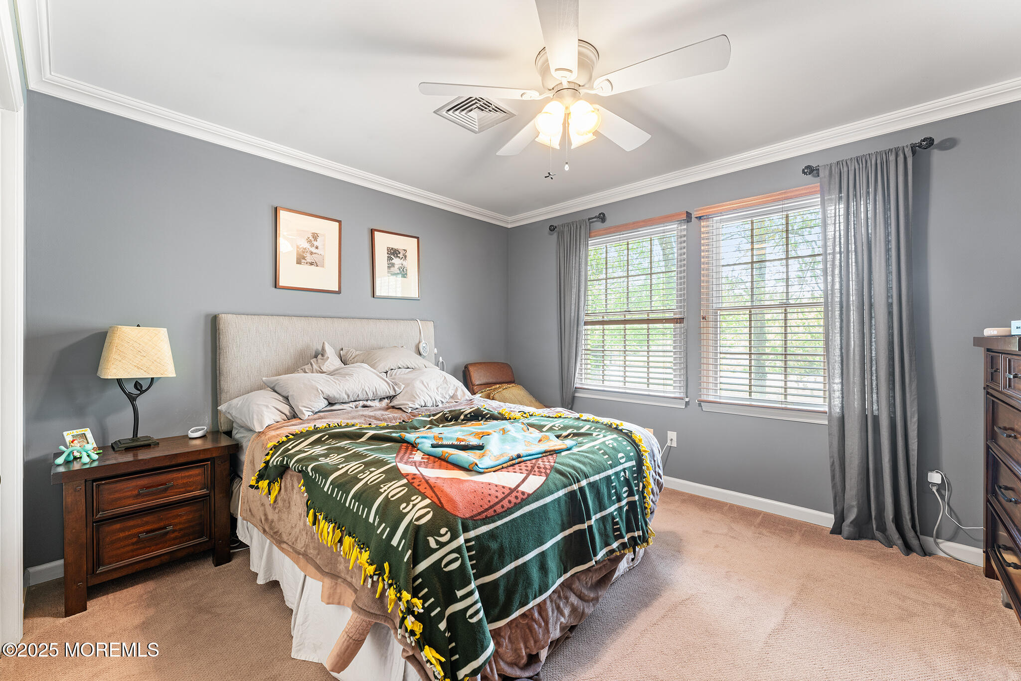 109 Merrick Road Farmingdale, NJ 07727 - Photo 32 of 62 a bedroom with a bed and a chandelier