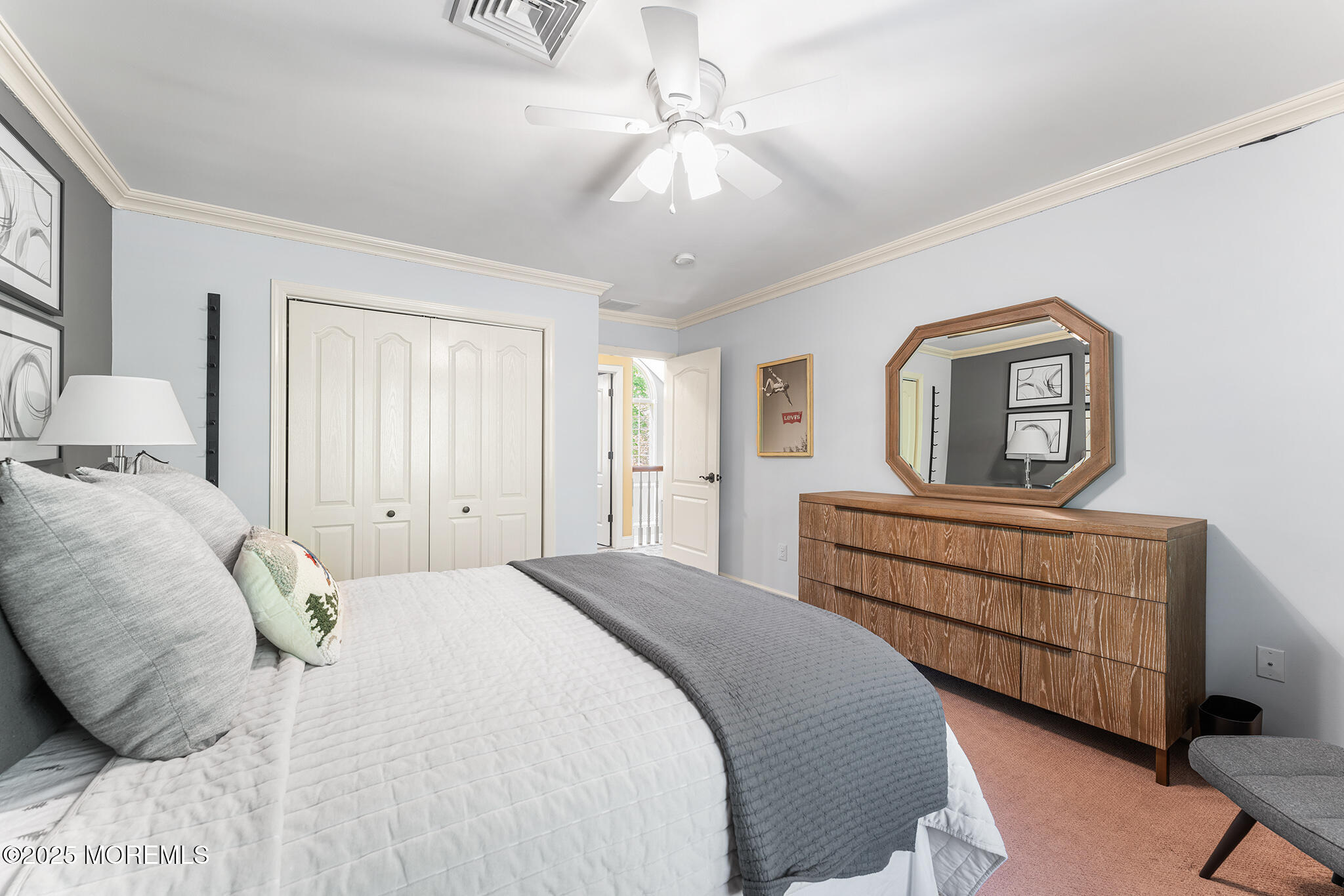 109 Merrick Road Farmingdale, NJ 07727 - Photo 36 of 62 a bedroom with a bed a chandelier and dresser