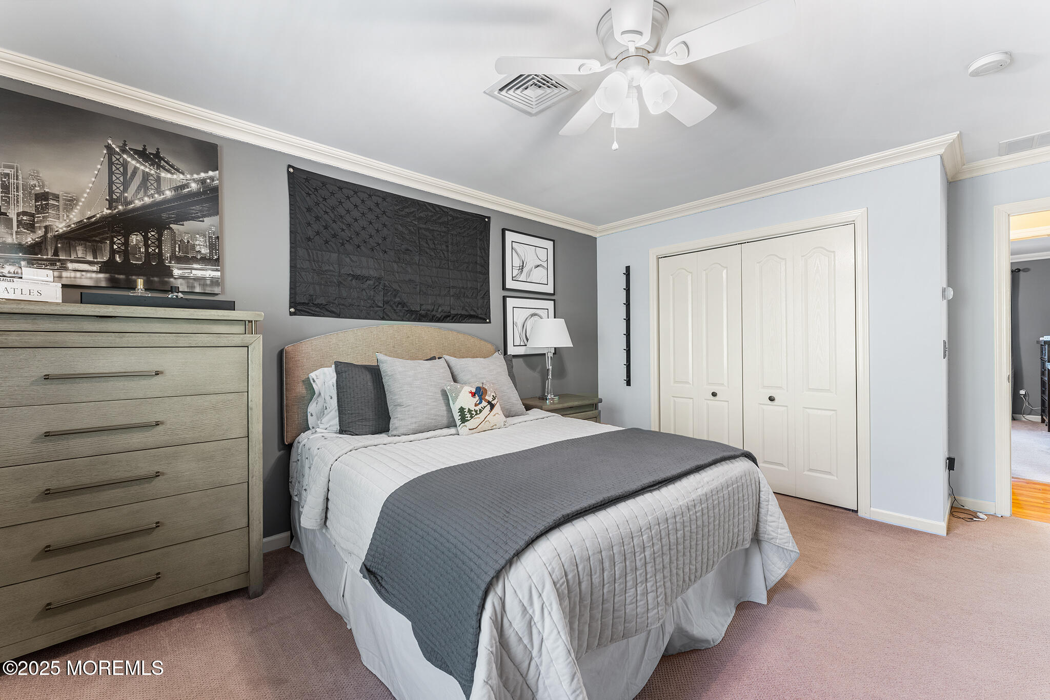 109 Merrick Road Farmingdale, NJ 07727 - Photo 37 of 62 a bedroom with a bed and a ceiling fan