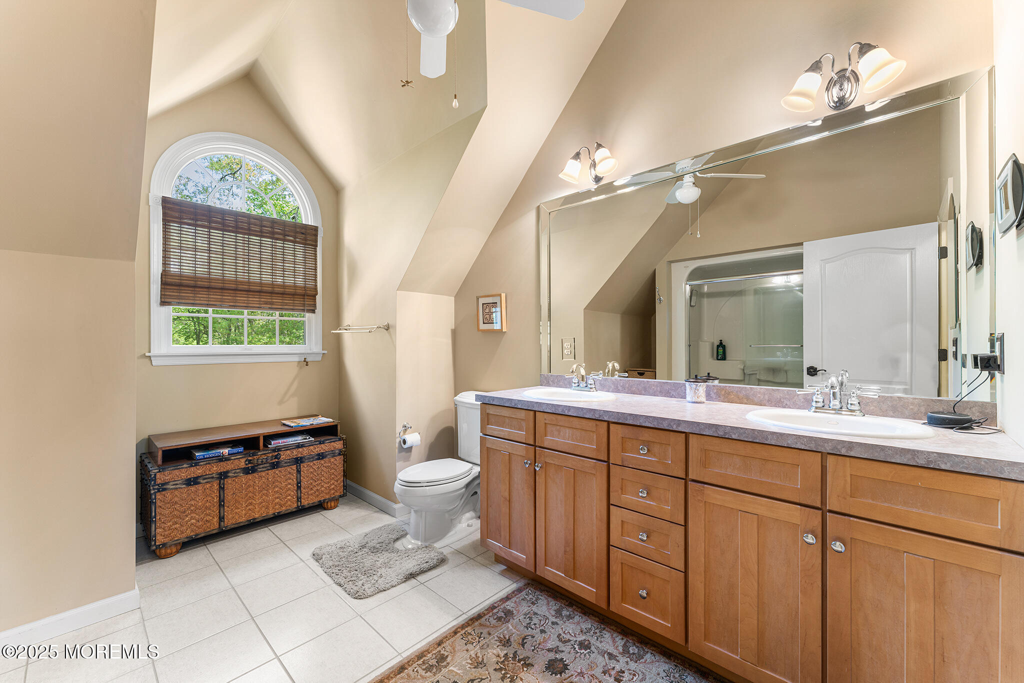 109 Merrick Road Farmingdale, NJ 07727 - Photo 38 of 62 a bathroom with a double vanity sink a toilet a mirror and shower