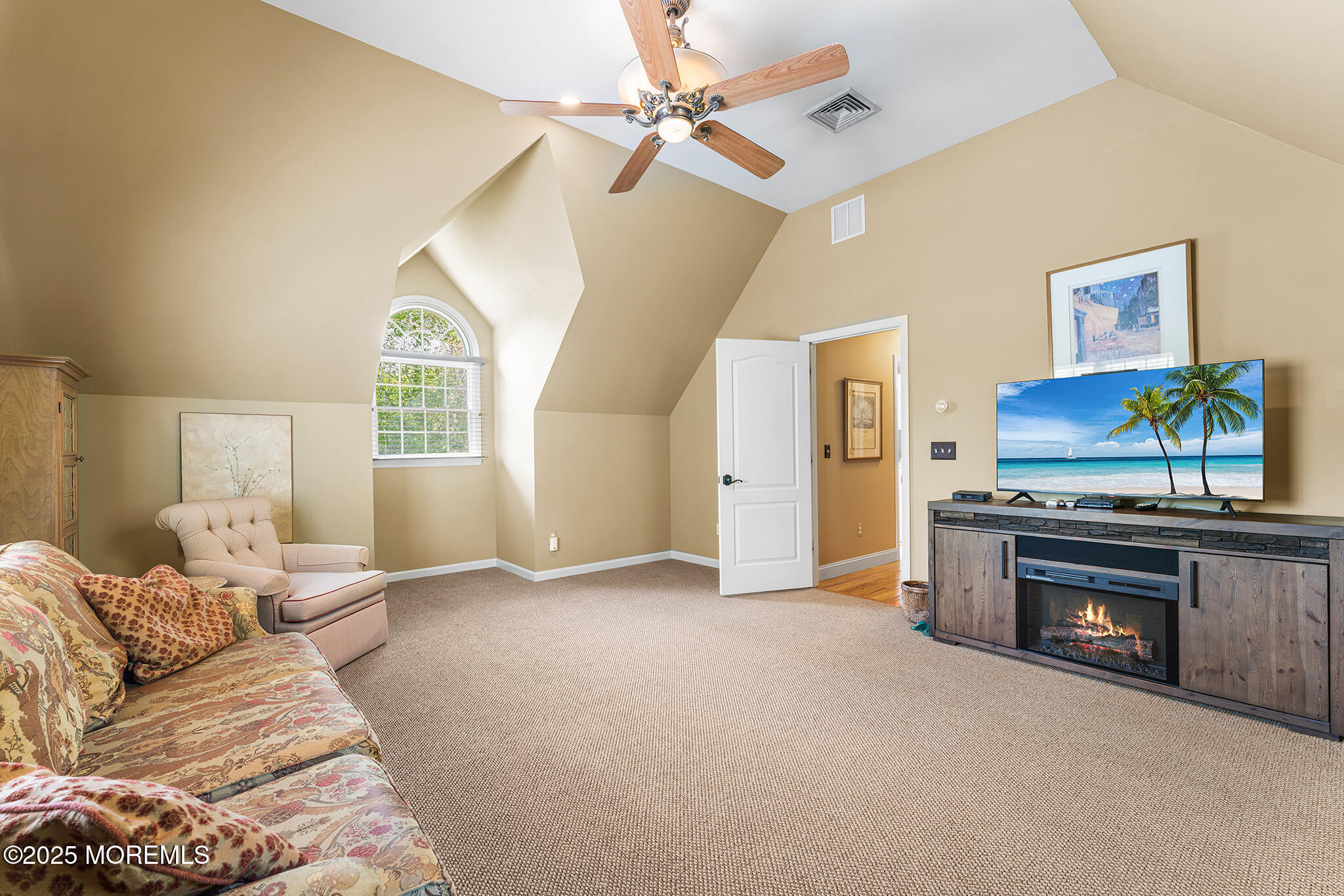 109 Merrick Road Farmingdale, NJ 07727 - Photo 42 of 62 a living room with furniture a chandelier and a fireplace