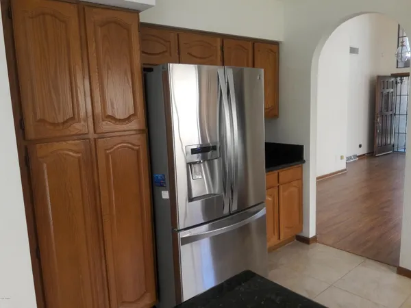 a metallic refrigerator freezer sitting in a kitchen