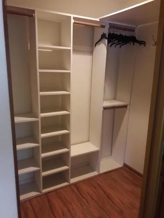 a view of walk in closet with empty racks