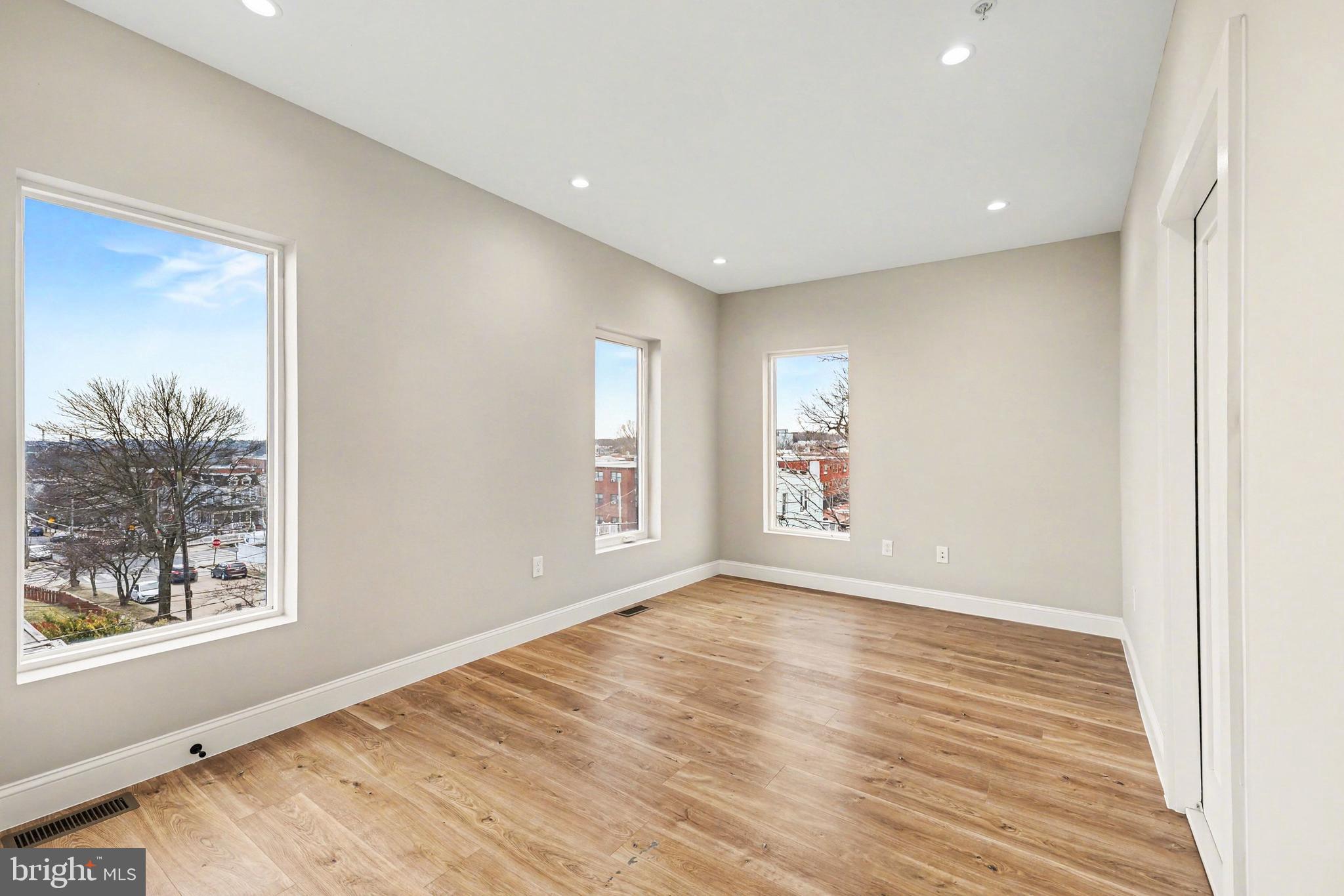 842 Madison Street Northwest, Unit 2 Washington, DC 20011 - Photo 12 of 27 a view of an empty room with a window and wooden floor