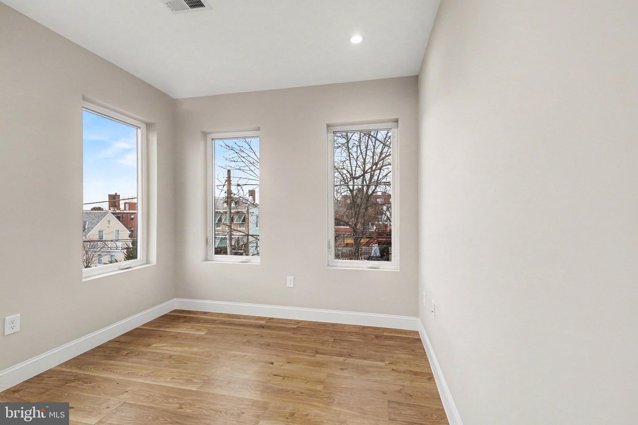 842 Madison Street Northwest, Unit 2 Washington, DC 20011 - Photo 16 of 27 an empty room with windows