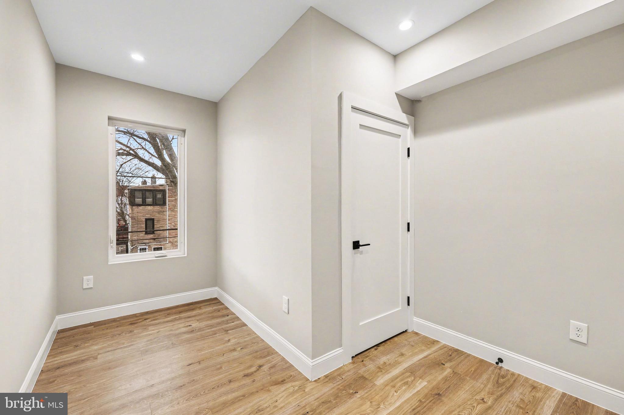 842 Madison Street Northwest, Unit 2 Washington, DC 20011 - Photo 20 of 27 a view of an empty room with wooden floor and a window