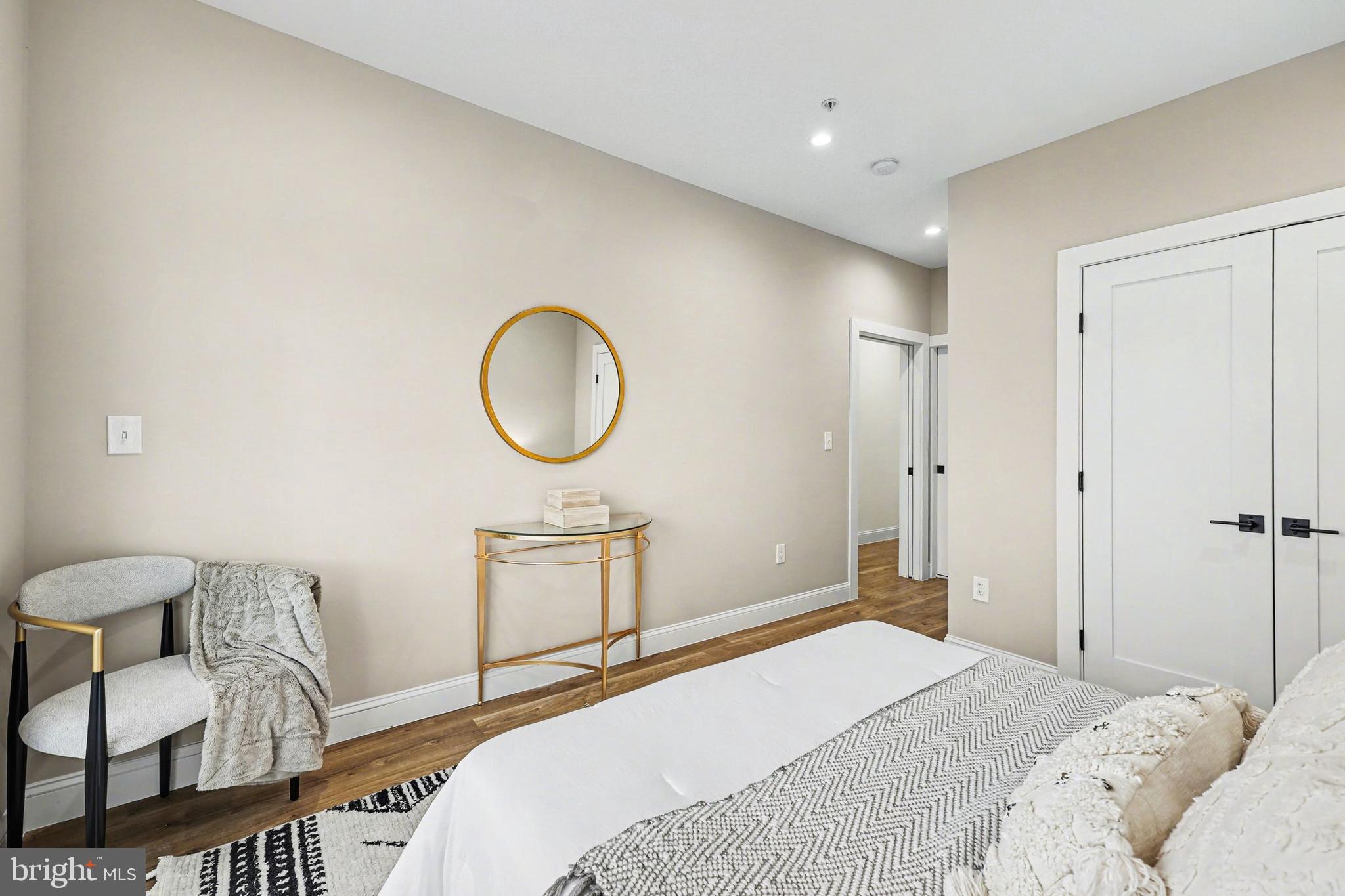 842 Madison Street Northwest, Unit 2 Washington, DC 20011 - Photo 9 of 27 a bedroom with a bed and a chandelier