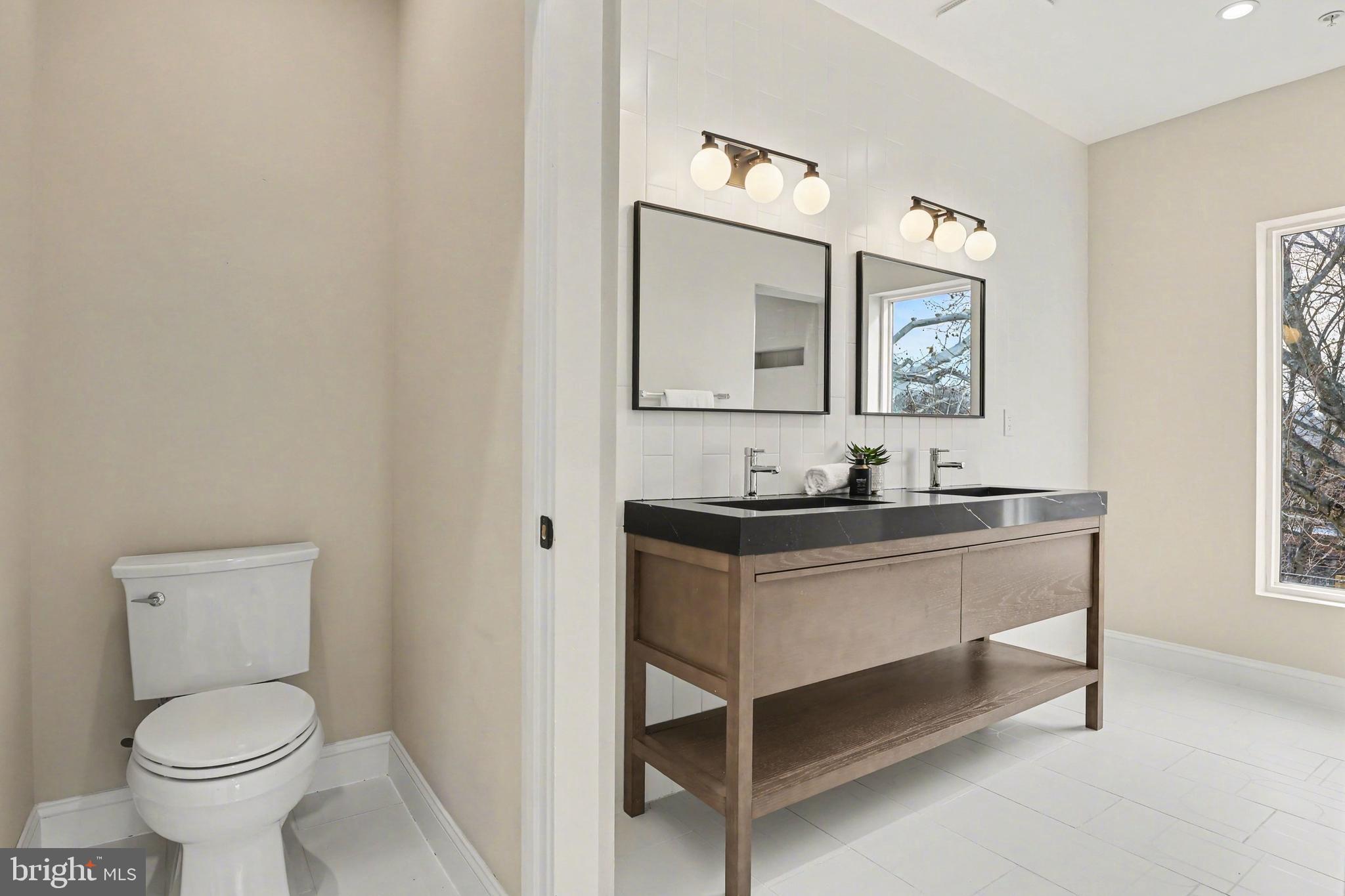 842 Madison Street Northwest, Unit 2 Washington, DC 20011 - Photo 10 of 27 a bathroom with a toilet a sink and mirror