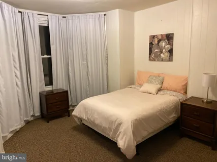 a bathroom with a sink vanity mirror and toilet