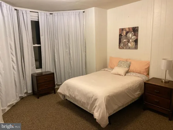 a bathroom with a sink vanity mirror and toilet