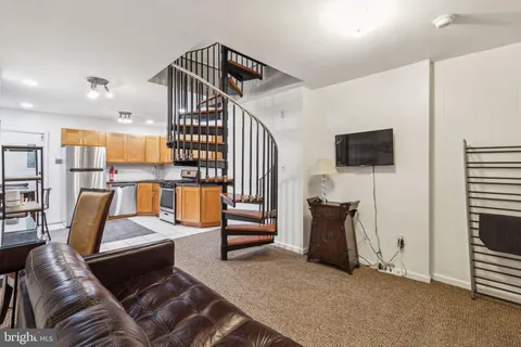 a view of kitchen with cabinets and flat screen tv