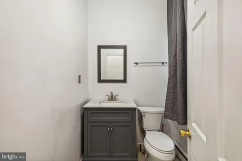 a bedroom with bed and cupboard