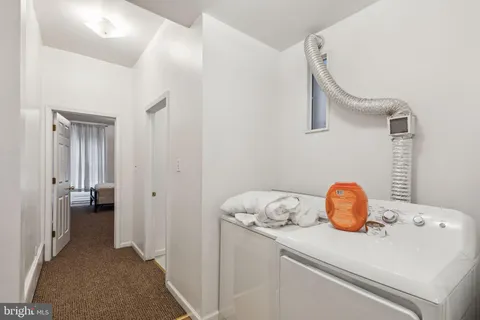 a view of an empty room with staircase