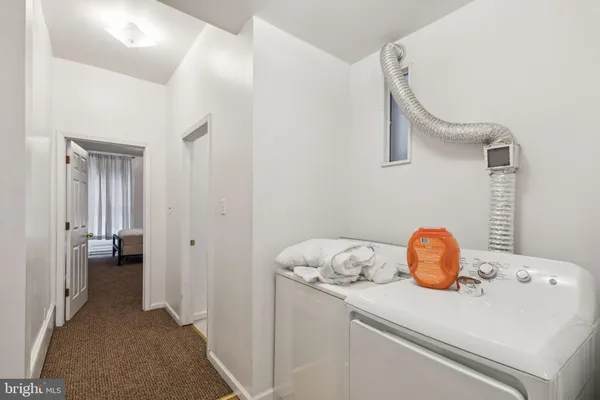 a view of an empty room with staircase