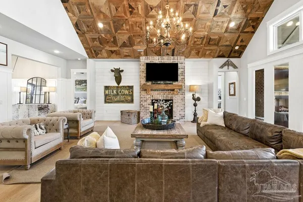 a living room with furniture and a chandelier