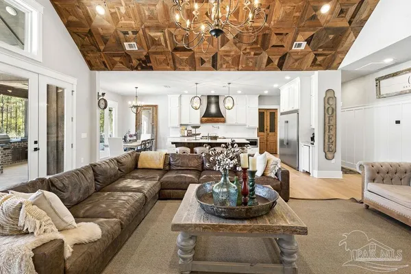 a kitchen with stainless steel appliances granite countertop a stove and a white cabinets