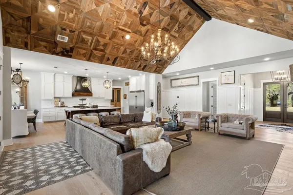 a kitchen with stainless steel appliances a refrigerator sink and white cabinets