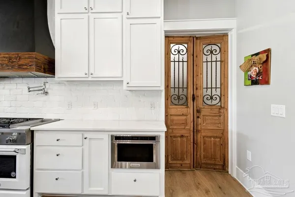 a spacious bathroom with a double vanity sink a mirror and a bathtub