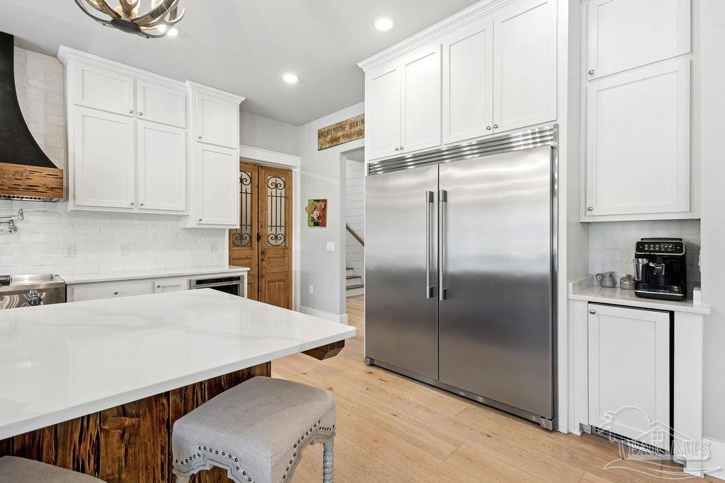 7520 Hidden Forest Trail Pace, FL 32571 - Photo 19 of 65 a kitchen with stainless steel appliances a refrigerator sink and white cabinets