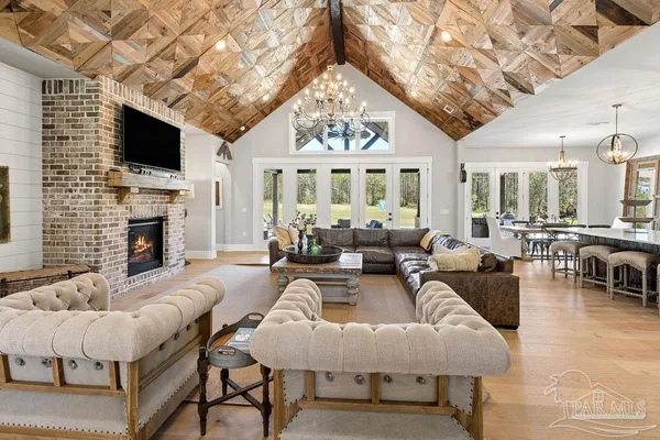 a living room with fireplace furniture and a flat screen tv