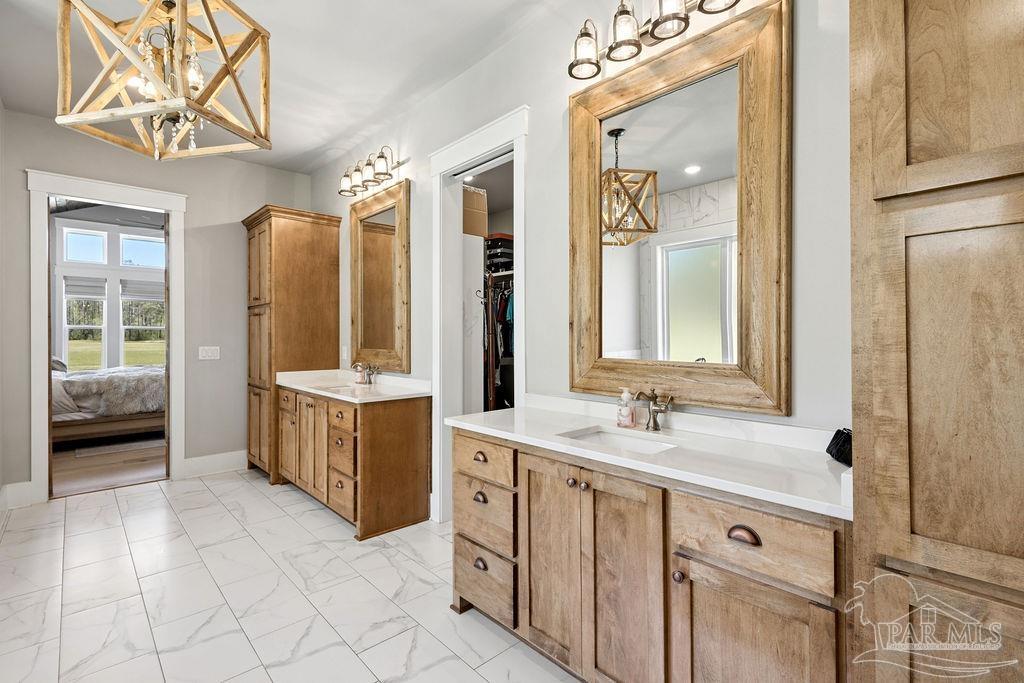 7520 Hidden Forest Trail Pace, FL 32571 - Photo 22 of 65 a spacious bathroom with a double vanity sink a mirror and a bathtub