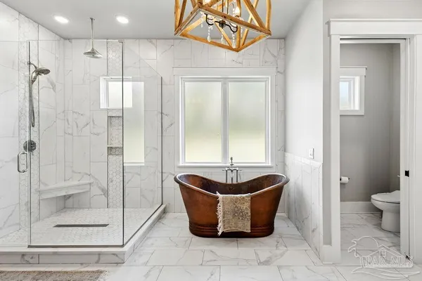 a bedroom with a bed couch and a window