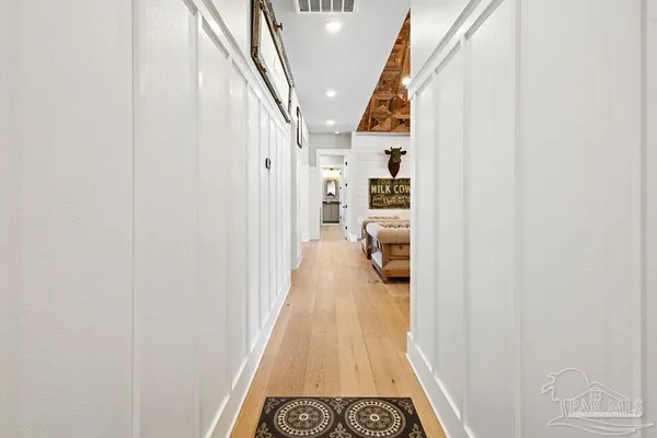a view of a hallway with paintings on the wall