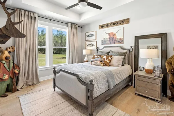 a room with pool table flat screen tv and windows