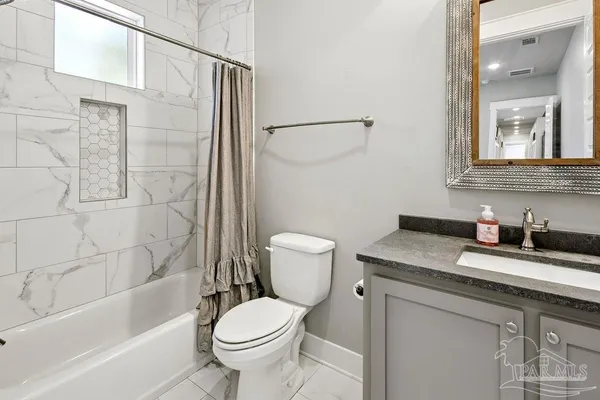 a spacious bedroom with a bed and a flat screen tv