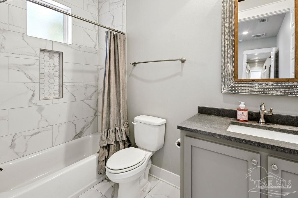 7520 Hidden Forest Trail Pace, FL 32571 - Photo 35 of 65 a bathroom with a granite countertop sink toilet and shower