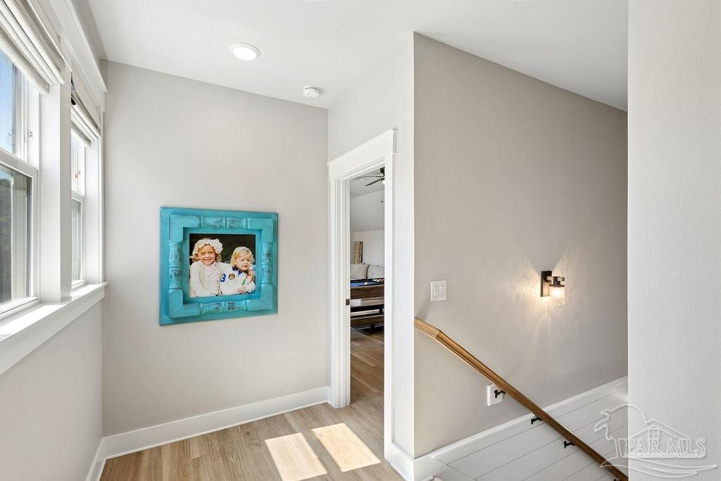 7520 Hidden Forest Trail Pace, FL 32571 - Photo 37 of 65 a view of a hallway with paintings on the wall