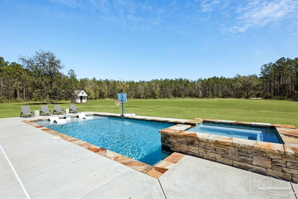 7520 Hidden Forest Trail Pace, FL 32571 - Photo 4 of 65 a view of a swimming pool and a yard