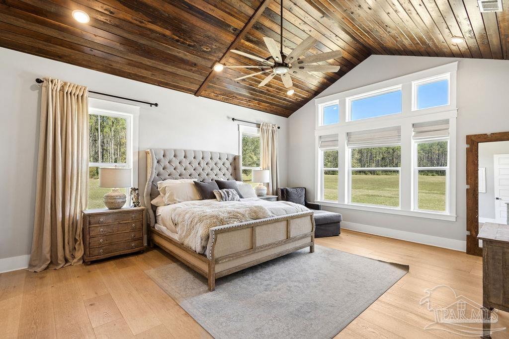 7520 Hidden Forest Trail Pace, FL 32571 - Photo 5 of 65 a spacious bedroom with a bed and a large window