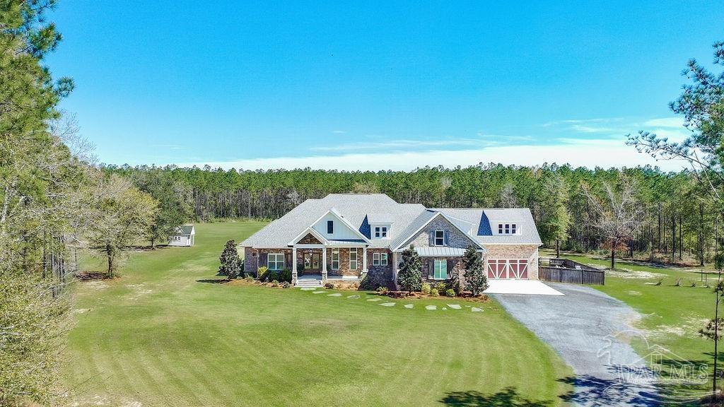 7520 Hidden Forest Trail Pace, FL 32571 - Photo 58 of 65 a front view of a house with garden