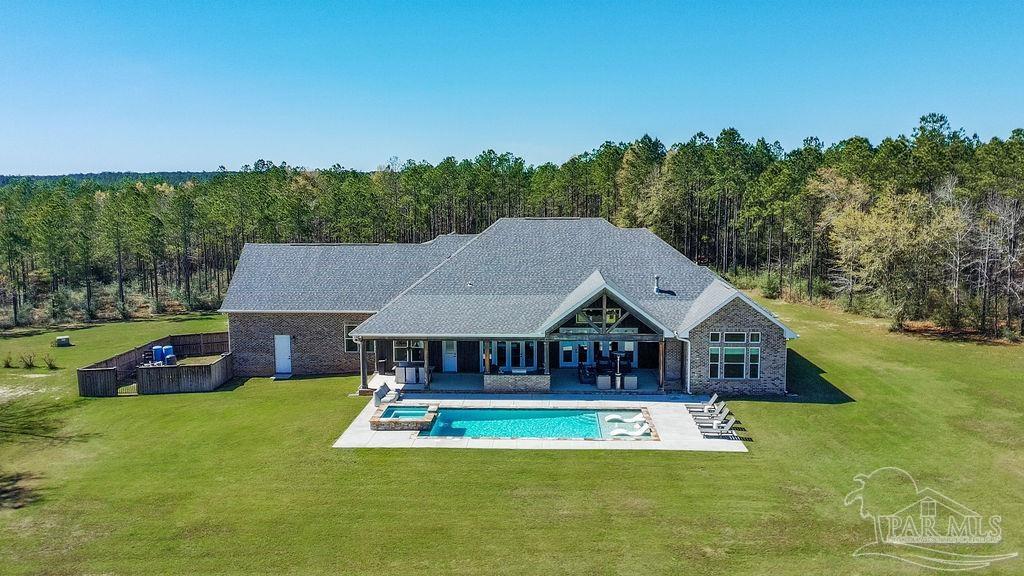7520 Hidden Forest Trail Pace, FL 32571 - Photo 61 of 65 a aerial view of a house with swimming pool yard and outdoor seating