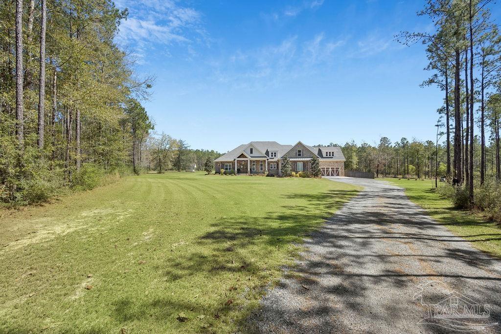 7520 Hidden Forest Trail Pace, FL 32571 - Photo 62 of 65 a view of a big yard with large trees
