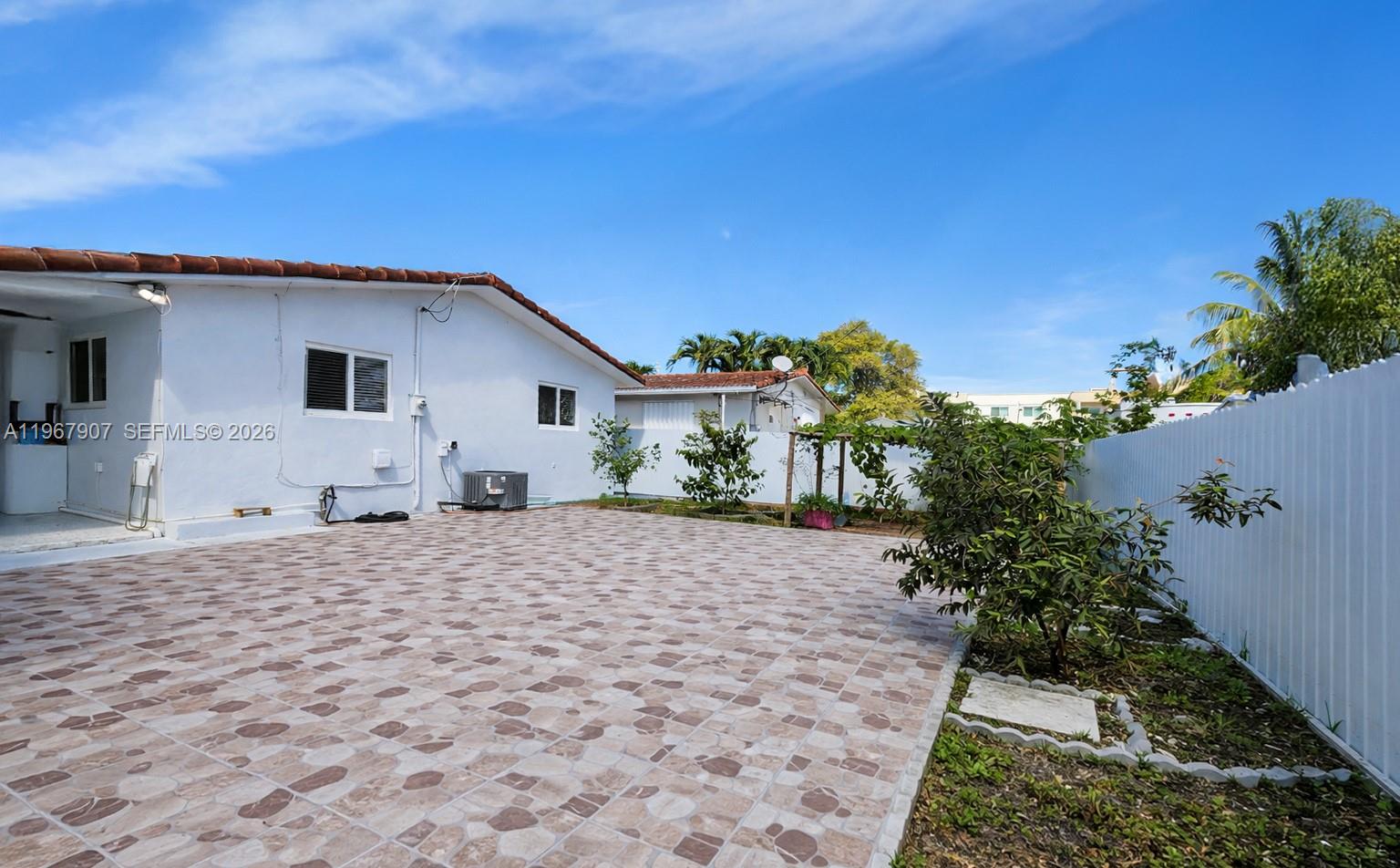 10360 Southwest 24th Street Miami, FL 33165 - Photo 13 of 14 a house with trees in the background