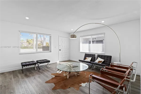 a living room with furniture a table and a window