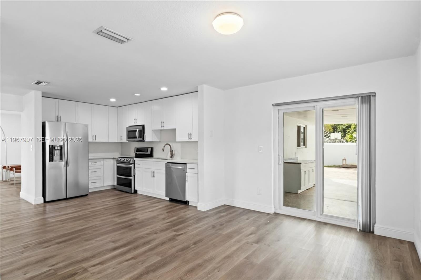 10360 Southwest 24th Street Miami, FL 33165 - Photo 5 of 14 a kitchen with stainless steel appliances a refrigerator and a stove top oven